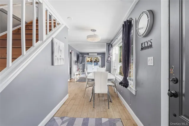a view of a hallway with wooden floor and entryway