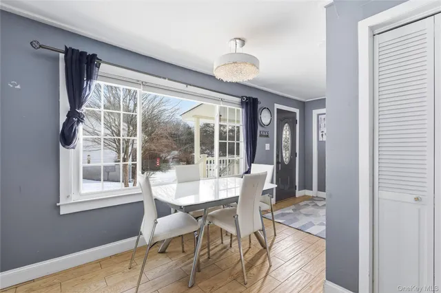 a view of a dining room with furniture wooden floor and chandelier
