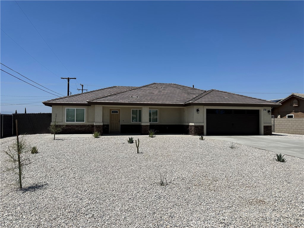 14002 Osage Road Apple Valley, CA 92307 - Photo 1 of 1 a front view of a house with a yard