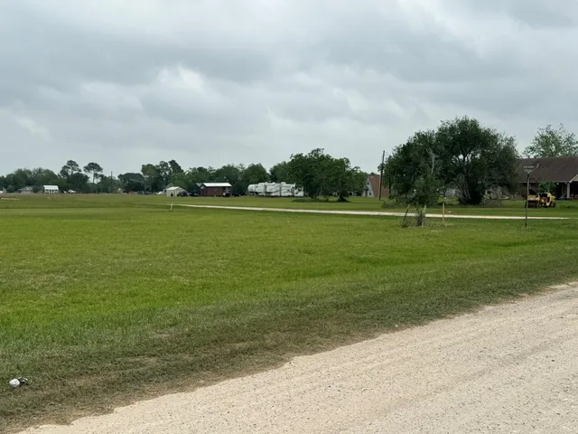 a view of a field with an ocean