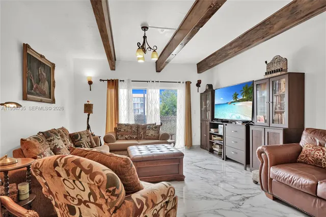 a living room with furniture ceiling fan and a rug