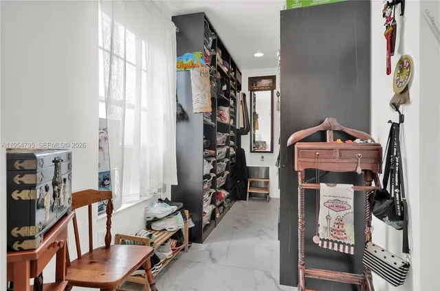 a view of walk in closet with clothes