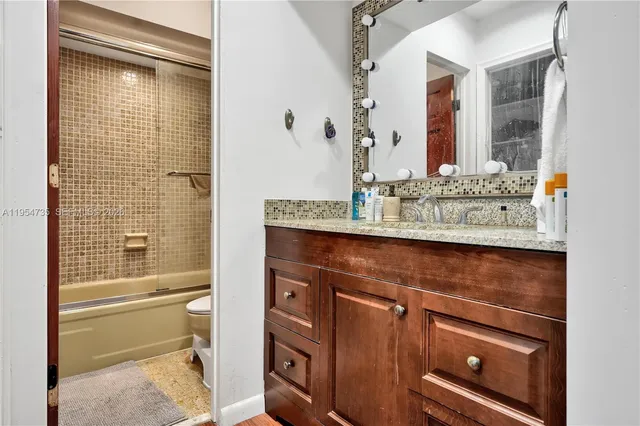 a bathroom with a sink a toilet and bathtub
