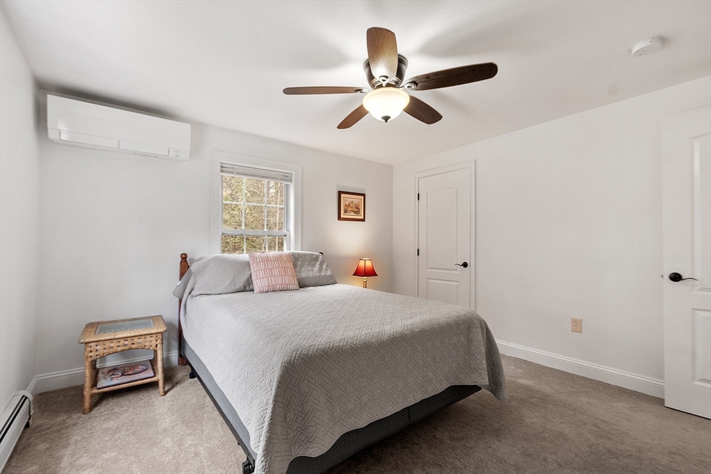 47 Brooks Village Road Phillipston, MA 01331 - Photo 27 of 41 a bedroom with a bed and a chandelier