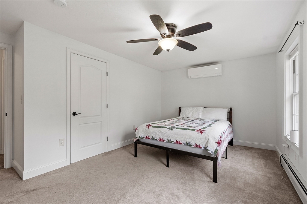 47 Brooks Village Road Phillipston, MA 01331 - Photo 28 of 41 a bedroom with a bed and a chandelier