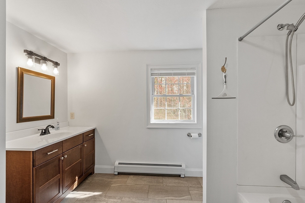 47 Brooks Village Road Phillipston, MA 01331 - Photo 30 of 41 a bathroom with a double vanity sink a mirror and a shower