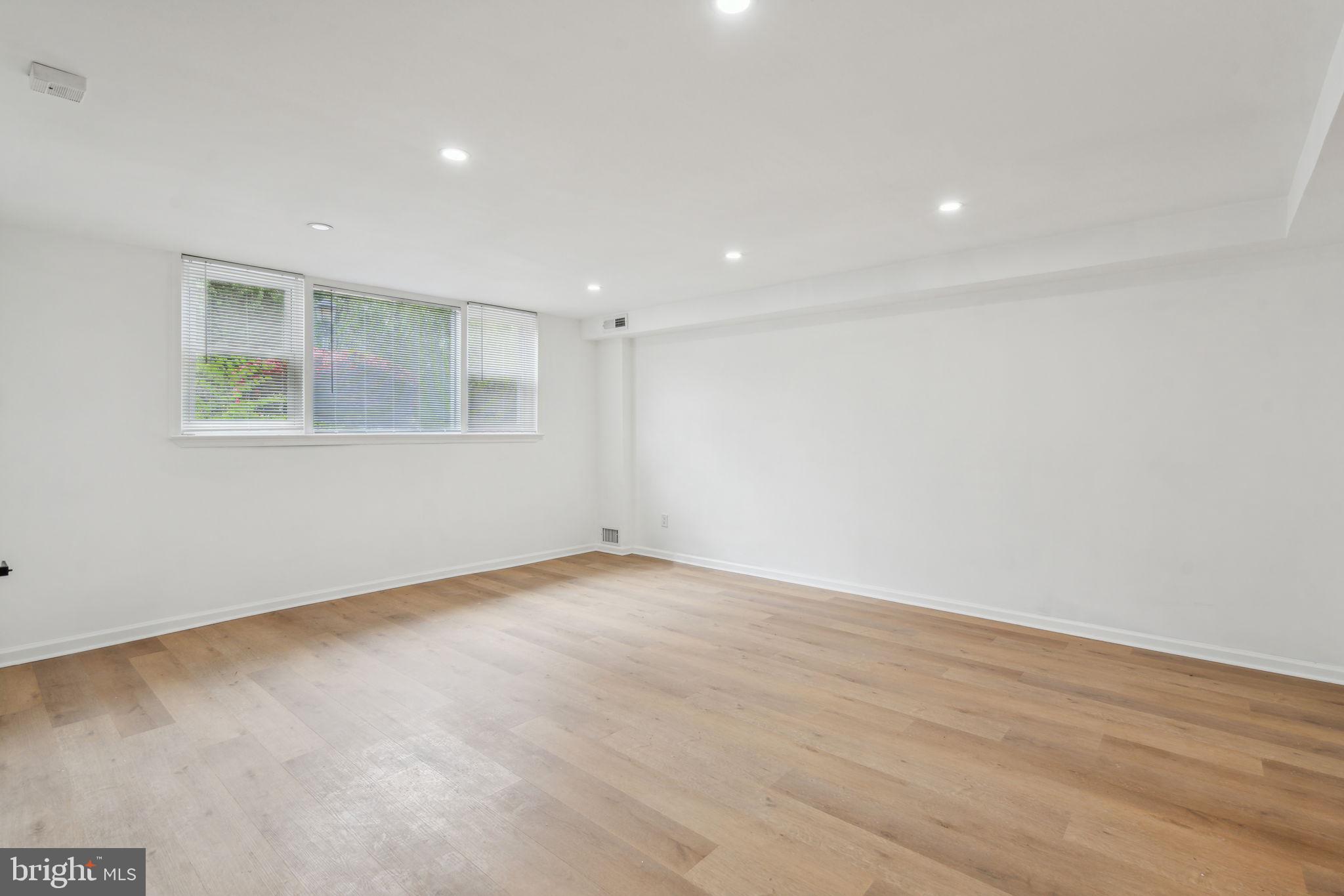 6901 Valley Avenue, Unit D1 Philadelphia, PA 19128 - Photo 4 of 19 an empty room with wooden floor and windows
