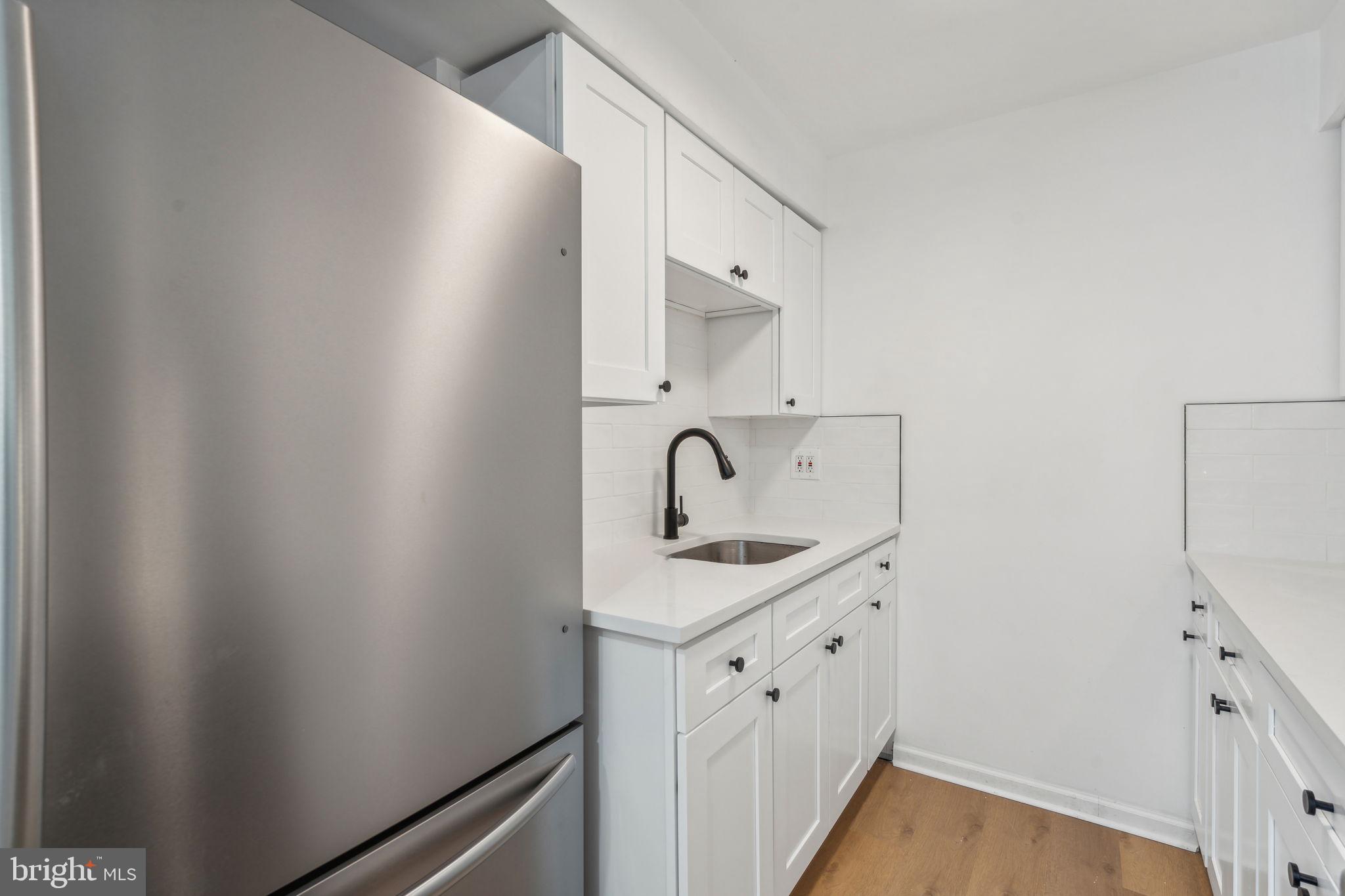 6901 Valley Avenue, Unit D1 Philadelphia, PA 19128 - Photo 7 of 19 a view of a bathroom with a sink and a mirror