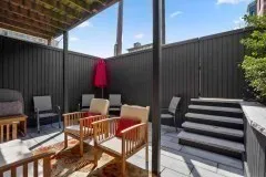 a view of balcony with two chairs and a potted plant