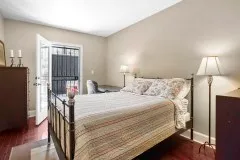 a bedroom with a bed and a lamp