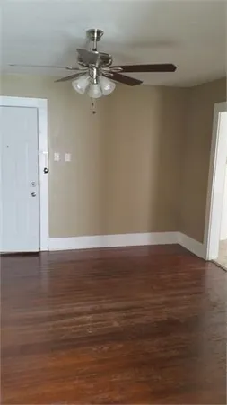 a view of a room with wooden floor