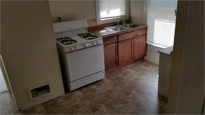 a kitchen with a stove and a refrigerator