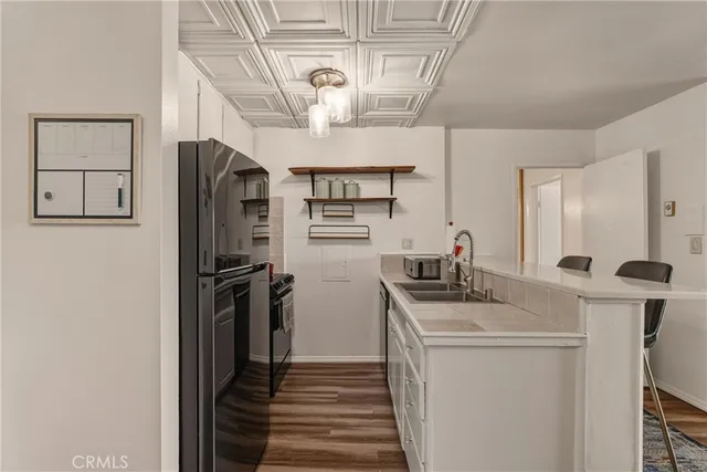 a kitchen with stainless steel appliances a refrigerator and a stove