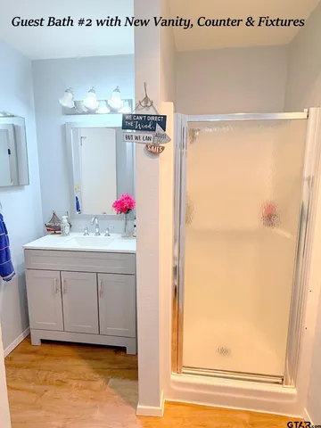 a bathroom with a sink vanity and a mirror