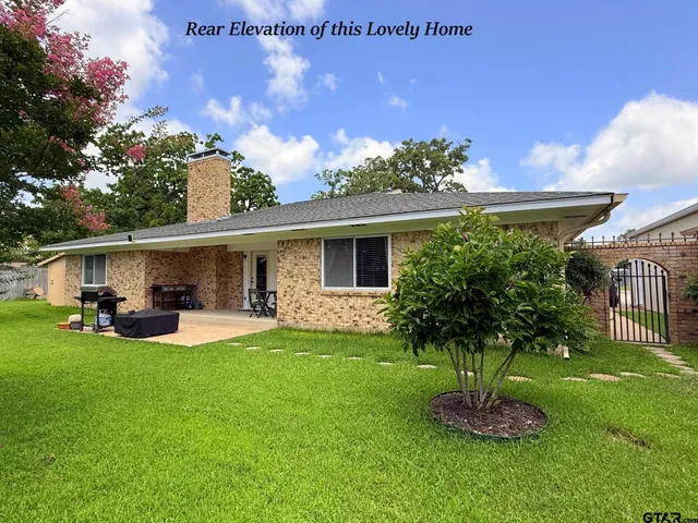 a front view of house with yard and outdoor seating