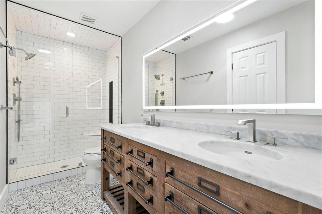 180 East Harpole Road Argyle, TX 76226 - Photo 18 of 38 a bathroom with a double vanity sink mirror and shower