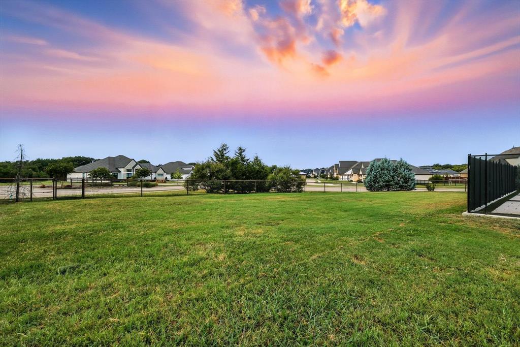 180 East Harpole Road Argyle, TX 76226 - Photo 28 of 38 a view of a green field with sunset in the background