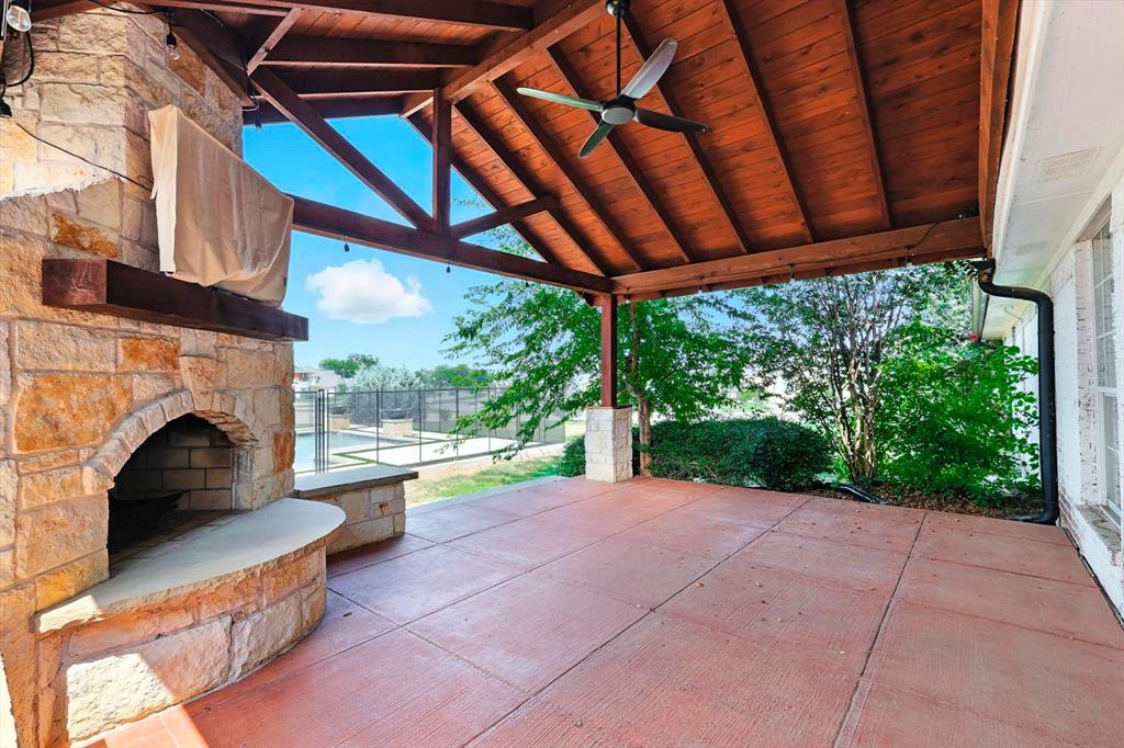 180 East Harpole Road Argyle, TX 76226 - Photo 35 of 38 a view of a patio with a table chairs and a fireplace