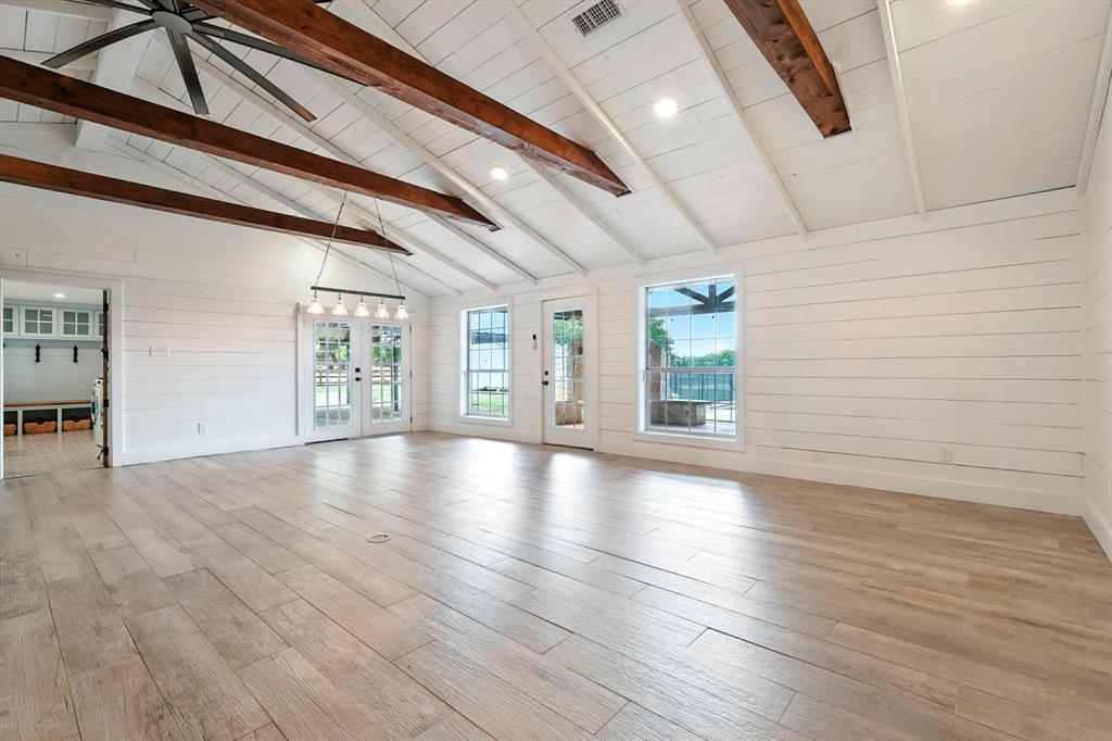 180 East Harpole Road Argyle, TX 76226 - Photo 5 of 38 an empty room with wooden floor and windows