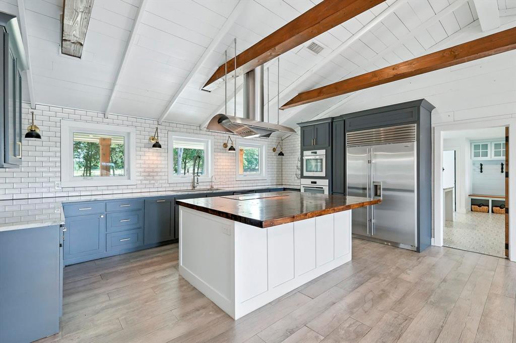 180 East Harpole Road Argyle, TX 76226 - Photo 9 of 38 a kitchen with stainless steel appliances granite countertop a sink and dishwasher a stove with wooden floor