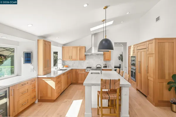 a kitchen with a table chairs and a view of living room