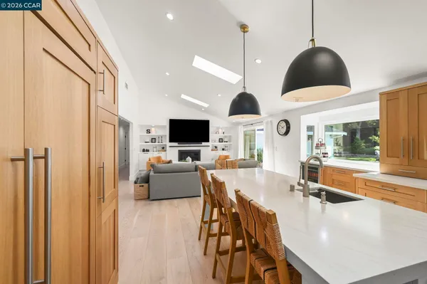 a kitchen with stainless steel appliances a sink a stove a counter space and cabinets