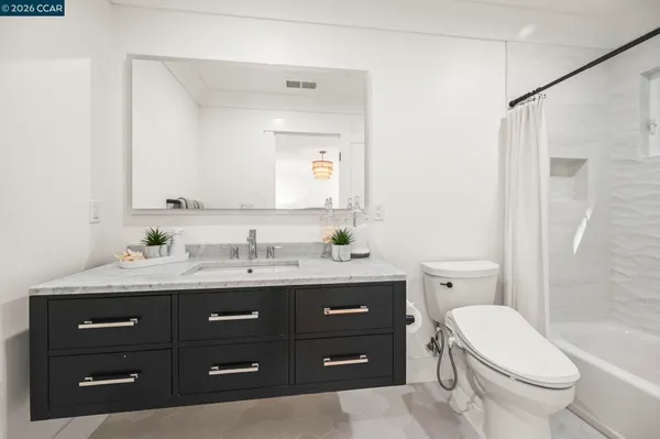 a bedroom with a bed and a couch