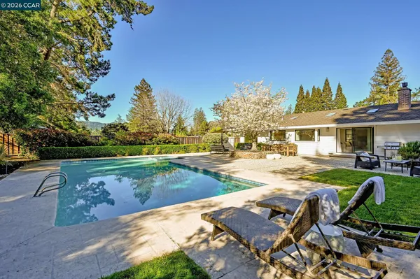 a view of a backyard with sitting area