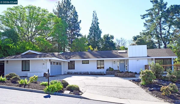 a couch sitting on a table and chairs in patio