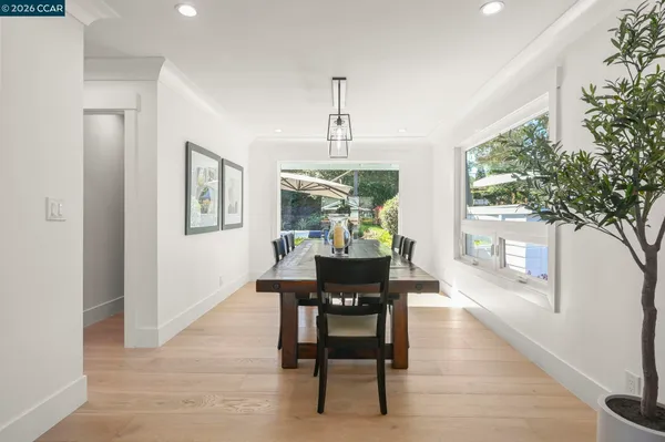 a large kitchen with kitchen island granite countertop a stove a sink a refrigerator and a wooden cabinets