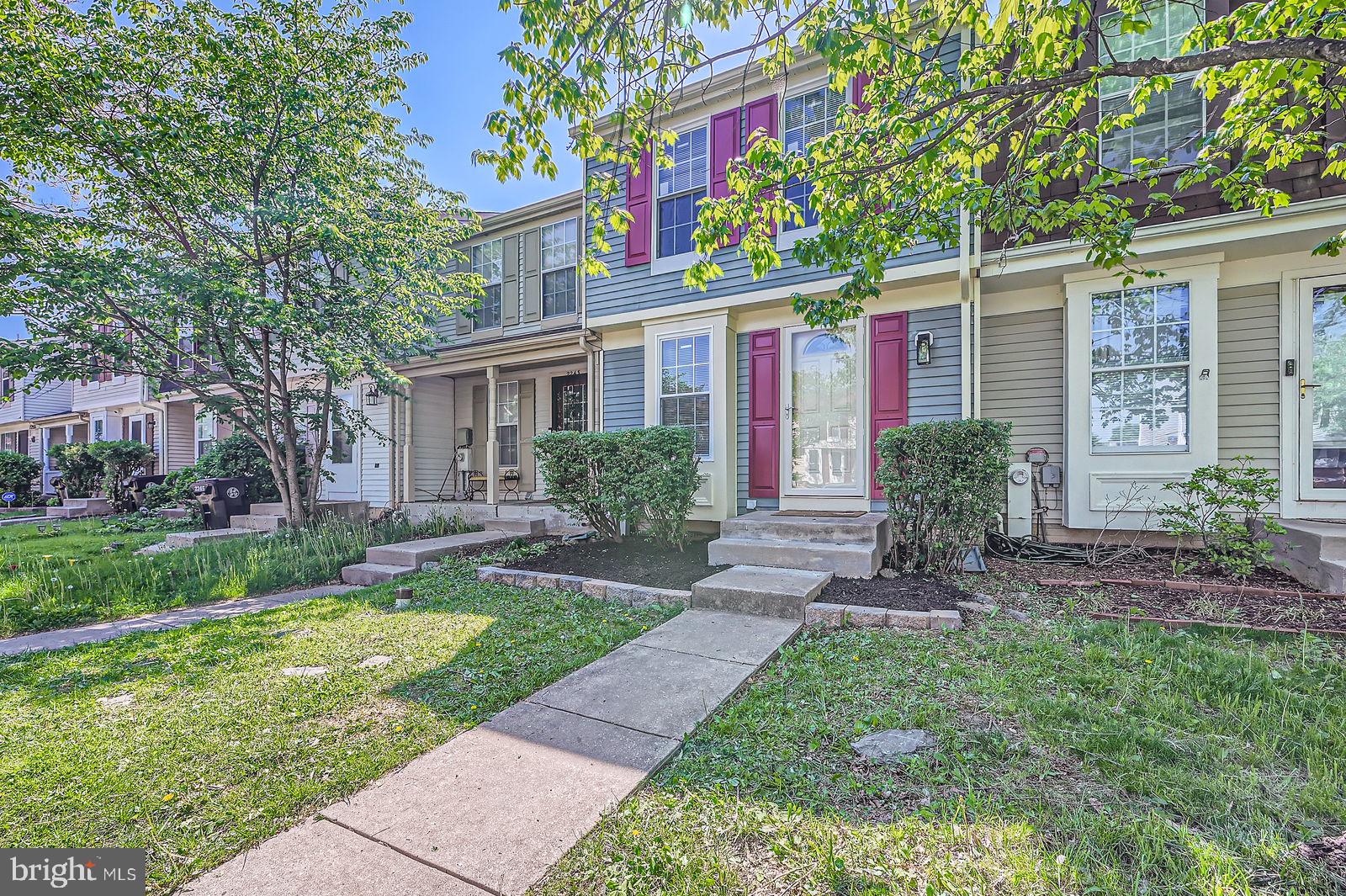 2241 Riding Crop Way Baltimore, MD 21244 - Photo 1 of 28 a front view of a house with a garden and plants