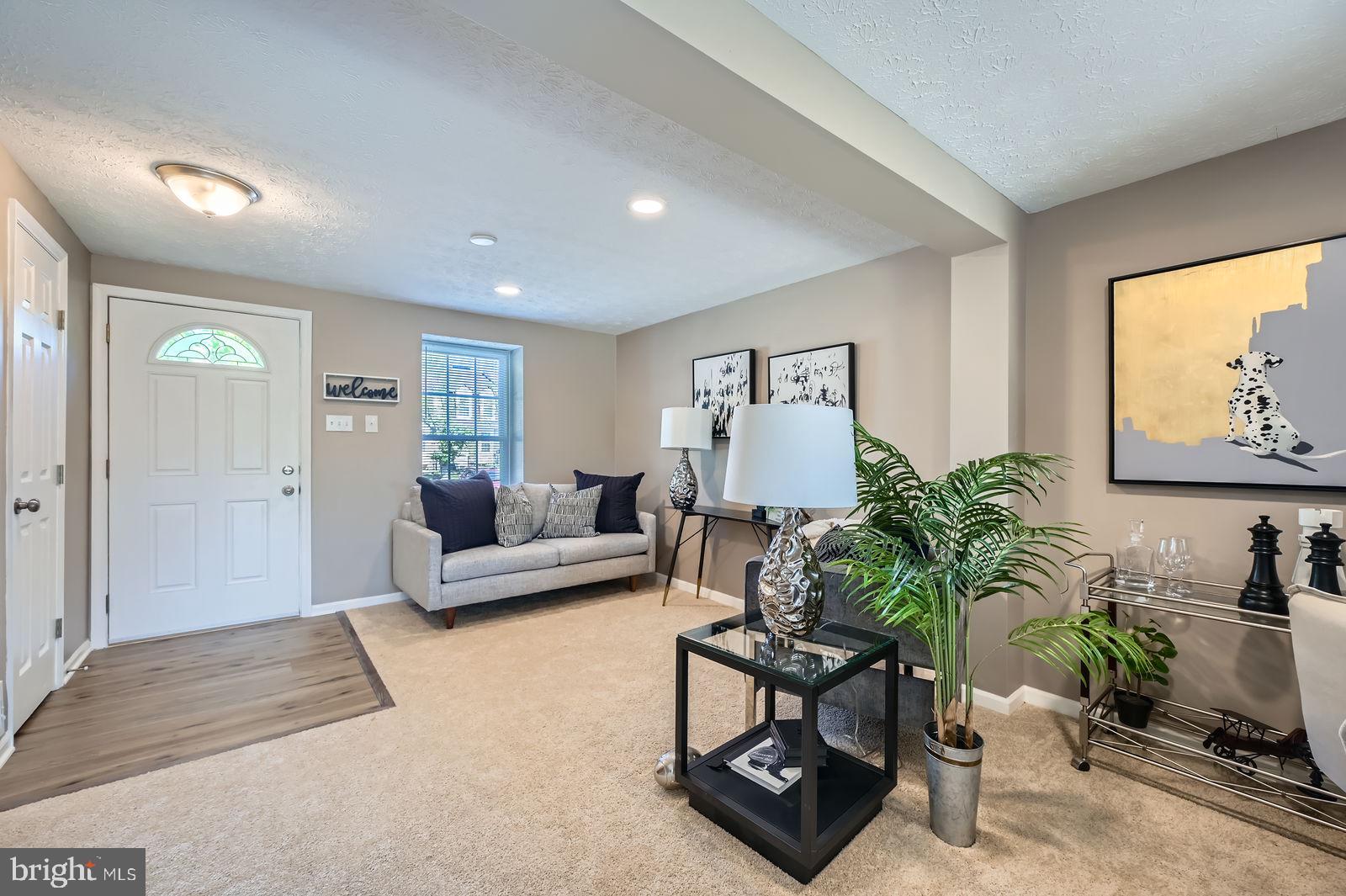 2241 Riding Crop Way Baltimore, MD 21244 - Photo 5 of 28 a living room with furniture potted plant and a window