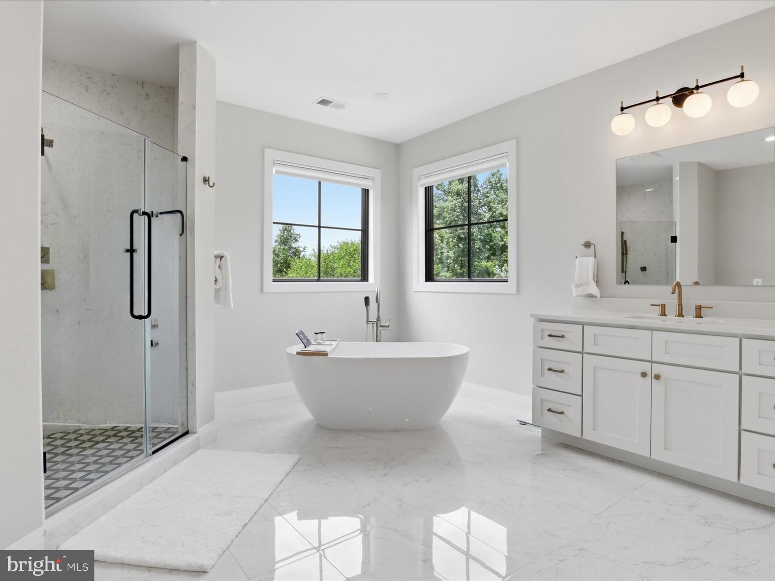 202 Branch Road Southeast Vienna, VA 22180 - Photo 34 of 59 a spacious bathroom with a shower sink and mirror