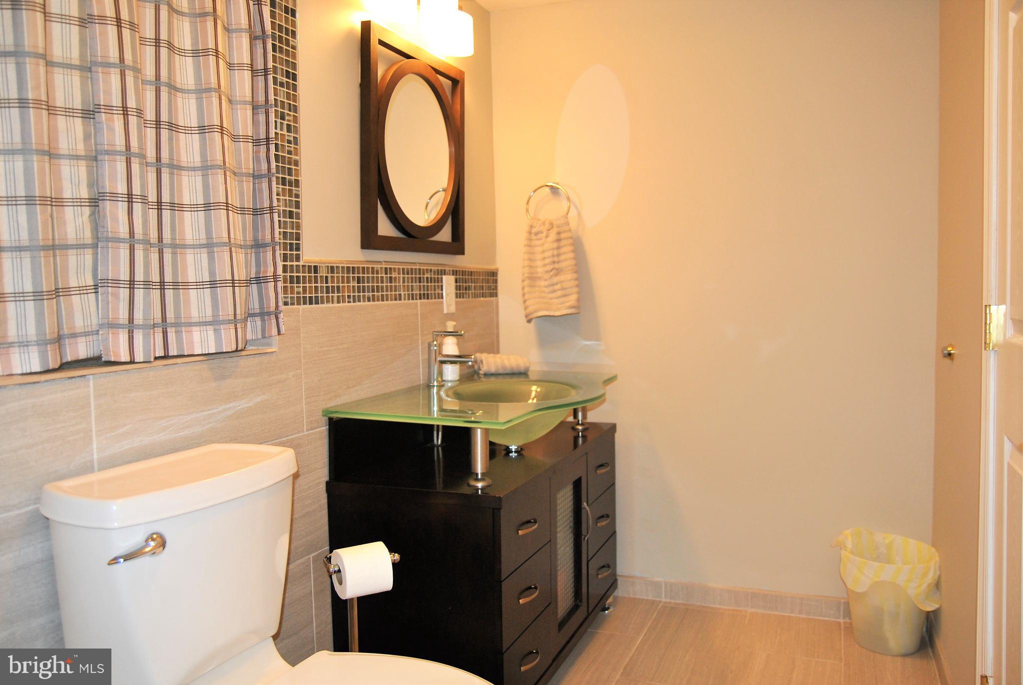 572 Highridge Road Front Royal, VA 22630 - Photo 18 of 26 a bathroom with a sink a toilet and a mirror