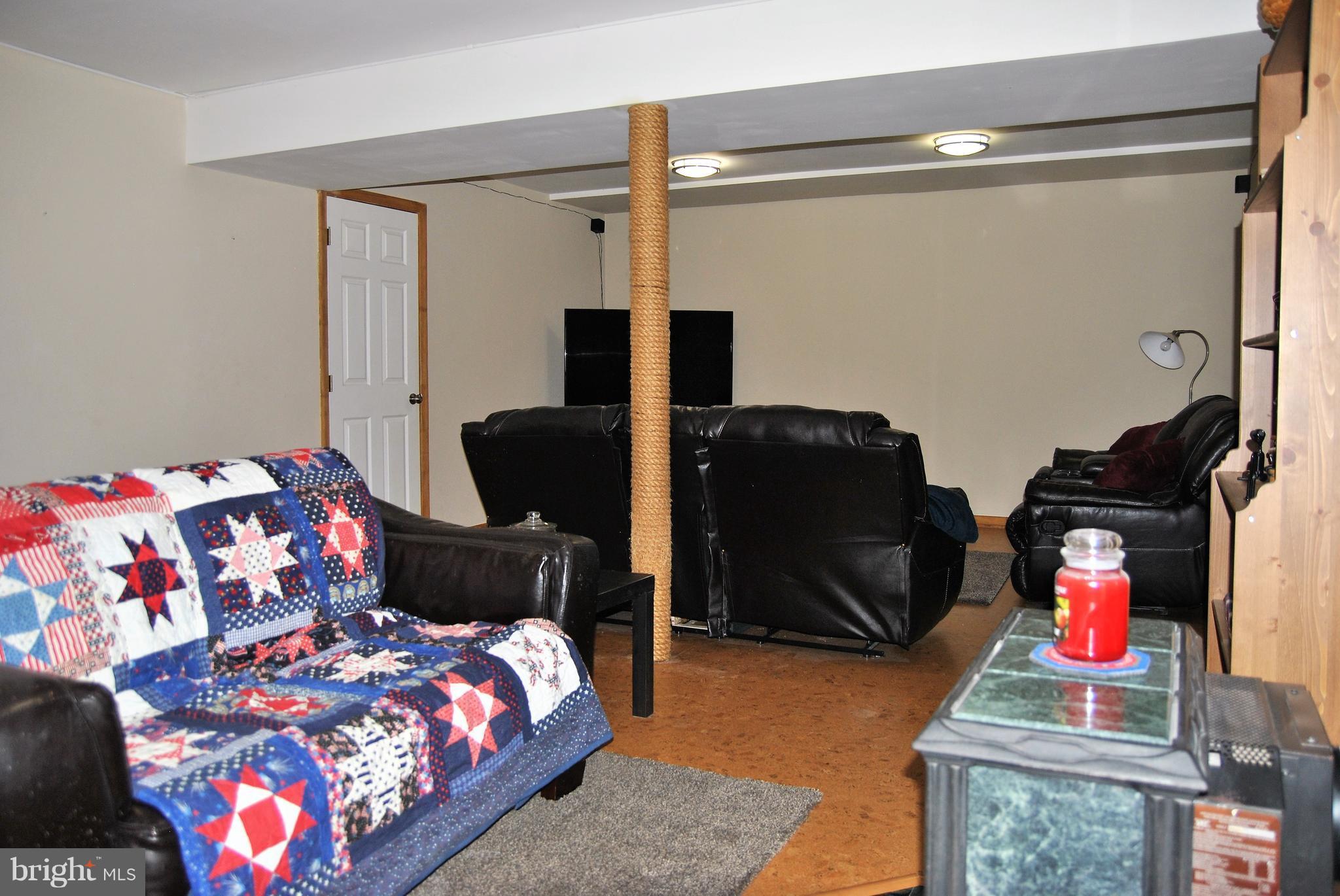 572 Highridge Road Front Royal, VA 22630 - Photo 20 of 26 a bedroom with a bed and wooden floor