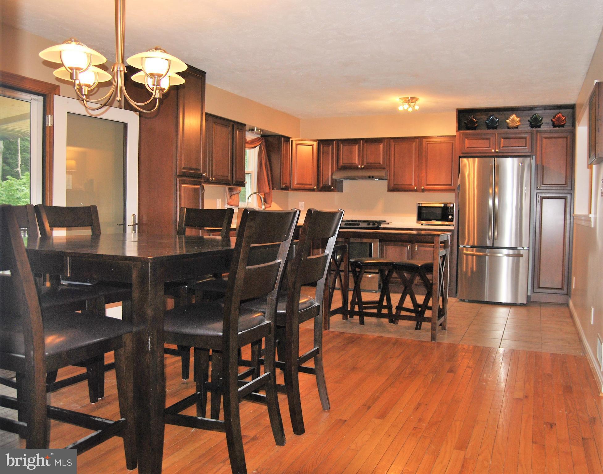 572 Highridge Road Front Royal, VA 22630 - Photo 3 of 26 a view of a dining room with furniture window and wooden floor