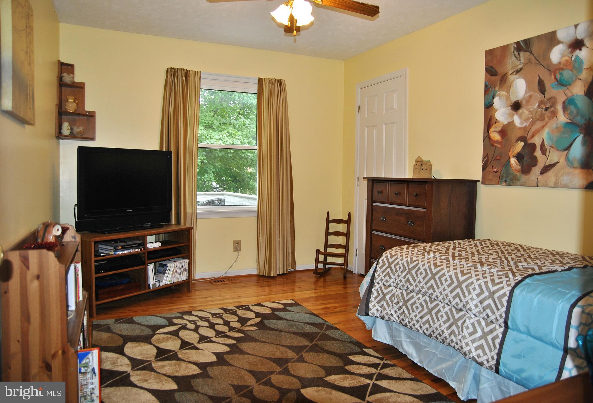 572 Highridge Road Front Royal, VA 22630 - Photo 7 of 26 a bedroom with a bed and flat screen tv