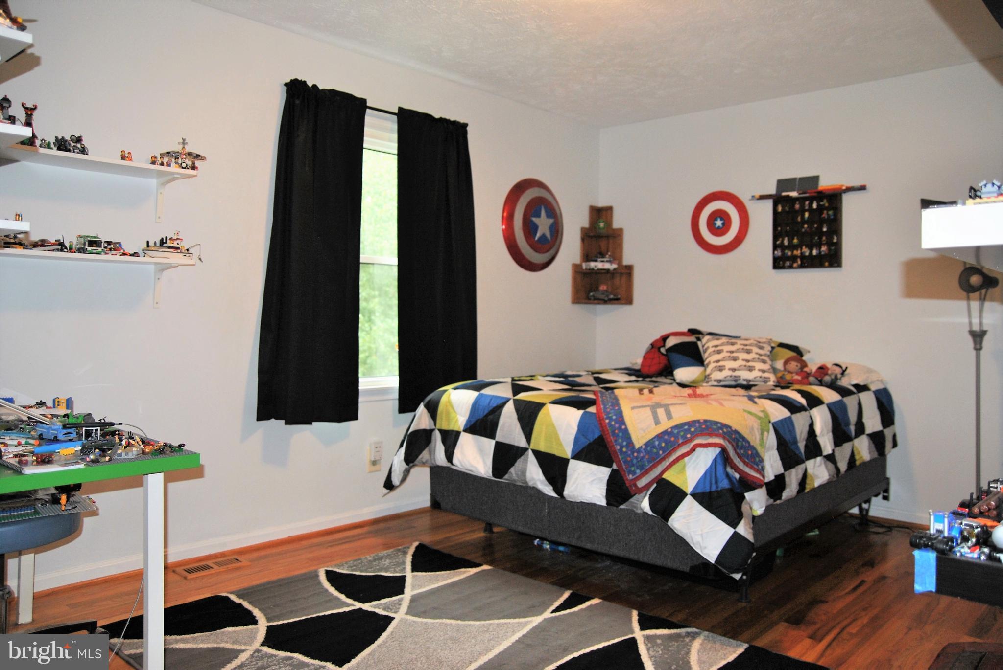 572 Highridge Road Front Royal, VA 22630 - Photo 9 of 26 a bedroom with a bed and a wall in it
