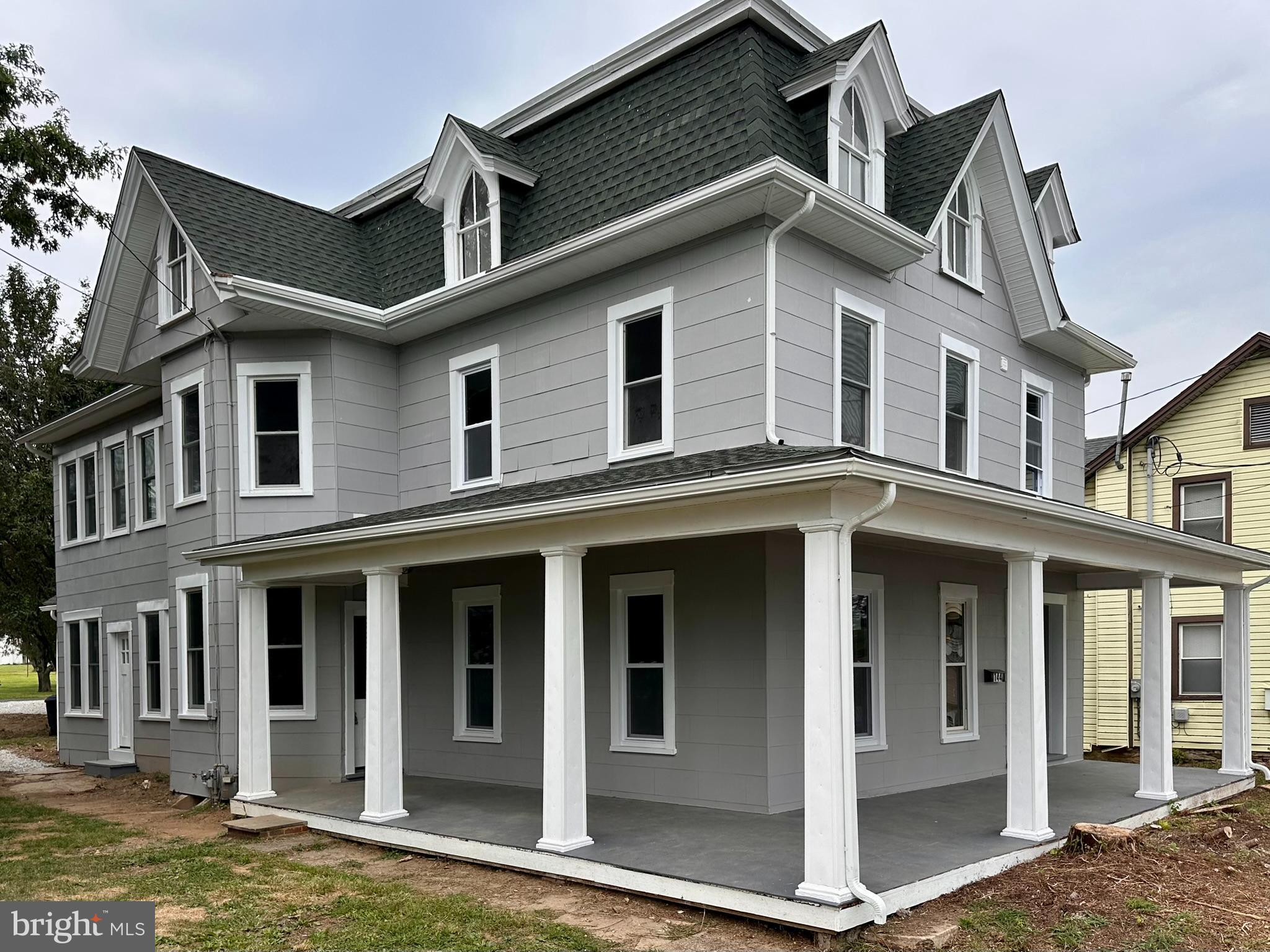 a front view of a house with a garden