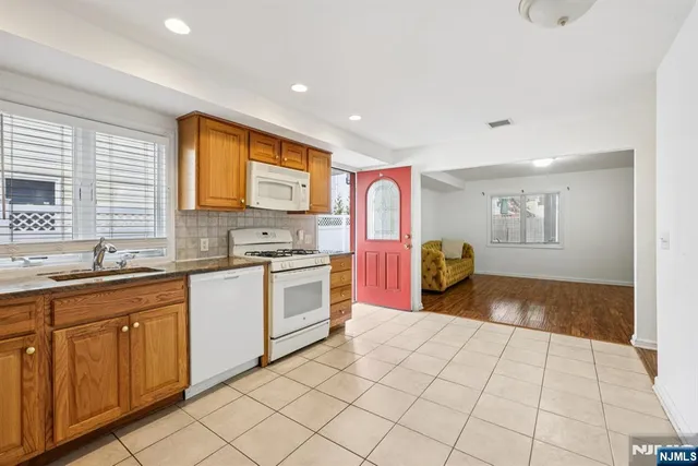 a kitchen with a sink cabinets and window