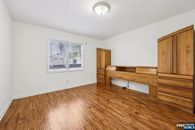 a living room with wooden floor and furniture
