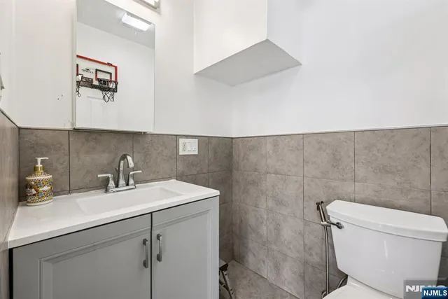 a bathroom with a sink mirror vanity and toilet