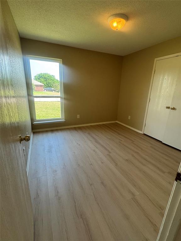 908 Cedar Ridge Lane Burleson, TX 76028 - Photo 17 of 24 an empty room with wooden floor and windows