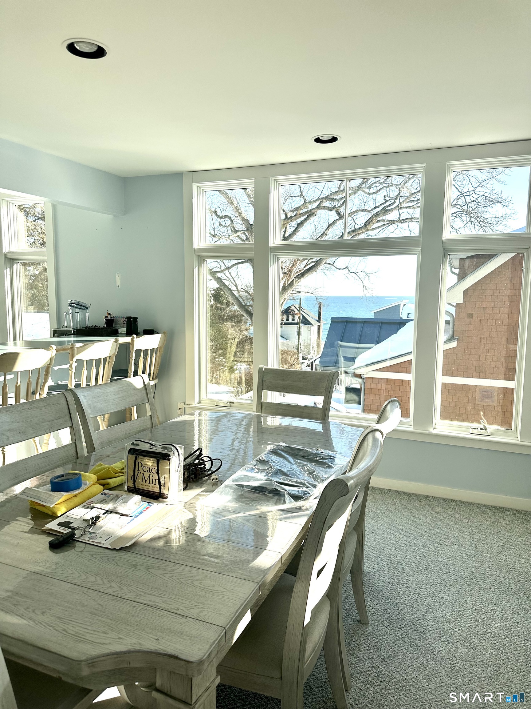 19 2nd Avenue Branford, CT 06405 - Photo 4 of 10 a dining room with furniture a large window and a chandelier