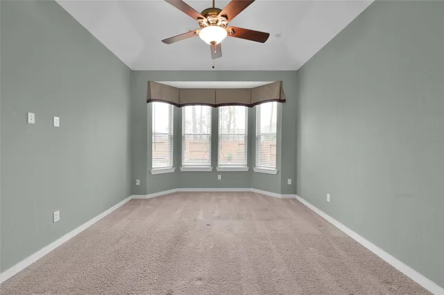 a view of room with furniture and a ceiling fan