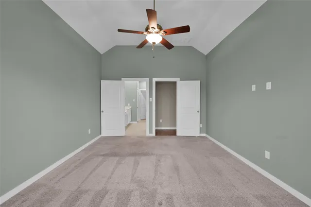 a view of an empty room with a fireplace and a window