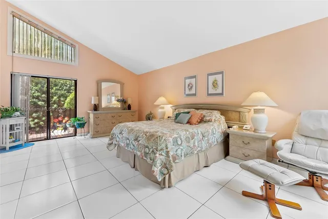 a spacious bedroom with a bed and a couch