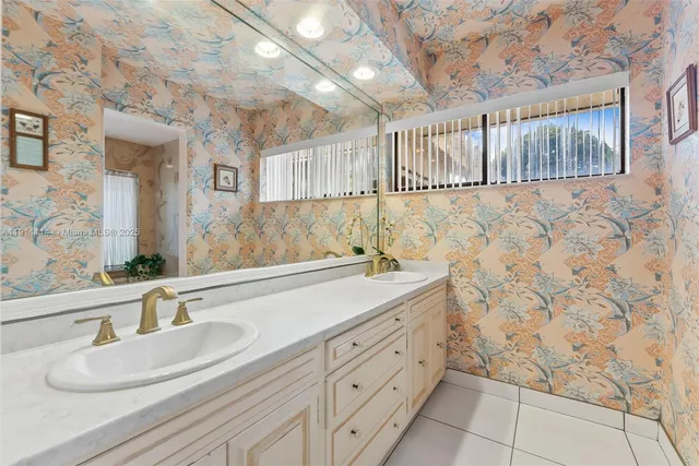 a bathroom with a granite countertop bathtub shower sink and toilet