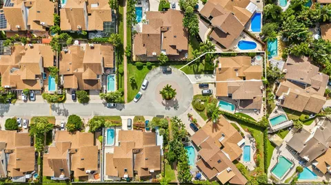 an aerial view of residential houses with outdoor space