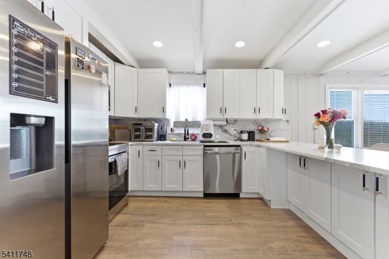26 Union Road Wantage, NJ 07461 - Photo 11 of 26 a kitchen with white cabinets stainless steel appliances and a window